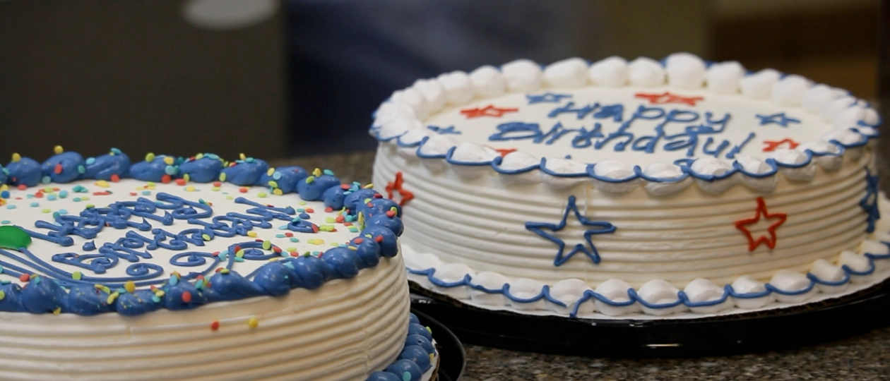 Two birthday cakes on a counter